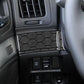 Close-up of carbon-fiber checkered steering button cover trim on vehicle console