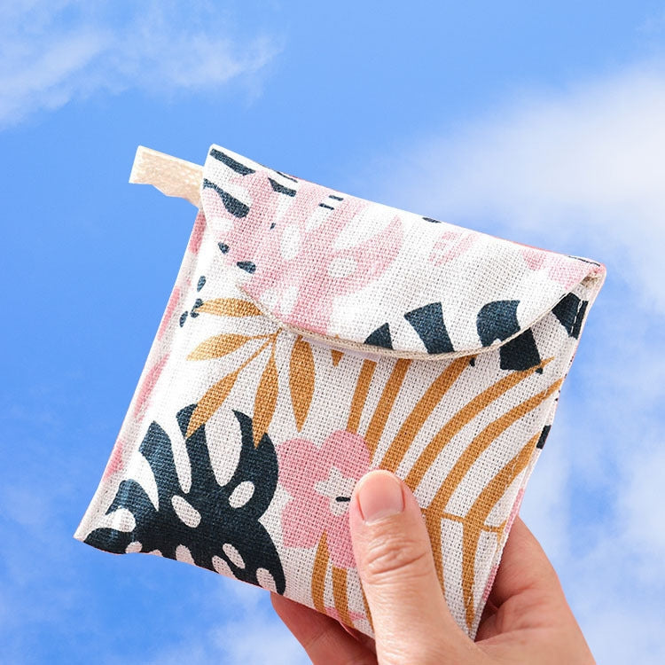 Handheld cotton-linen pouch with pink, orange, and black animal pattern snap flap