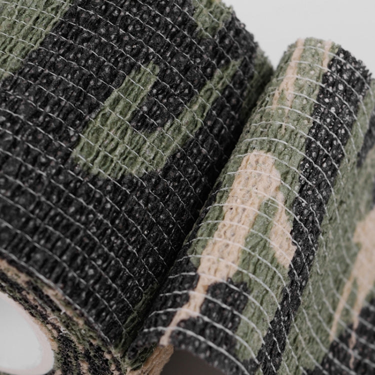 Close-up of camouflage non-woven tape texture on rolled edge, dark and green