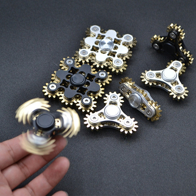 Four-gear fidget spinner cluster with silver and black styles, hand holding one spinner.