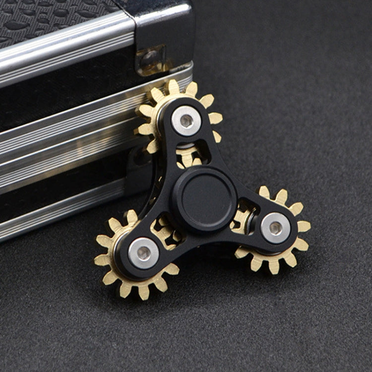 Four-gear fidget spinner with black frame, gold-tone gears, and dark center disc.