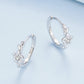 Sterling silver hoop earrings with flower-vine details and a round zircon