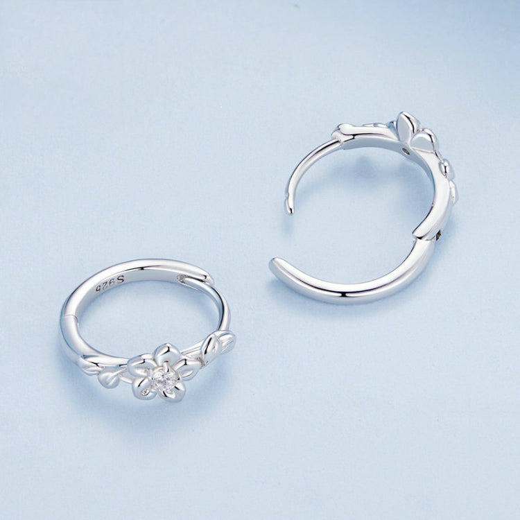 Sterling silver hoop earrings with flower-vine motif and round zircon centerpiece
