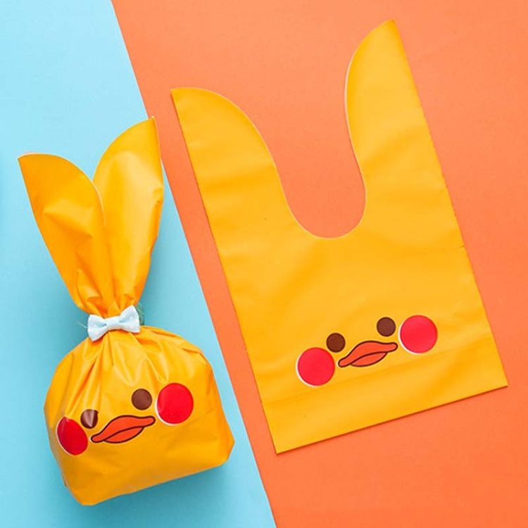 Rabbit-ear gift bag, yellow with red nose and winking cartoon bunny face.