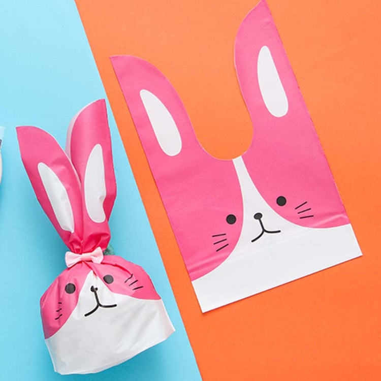 Rabbit-ear gift bag, pink and white with bunny face print, tied closed.