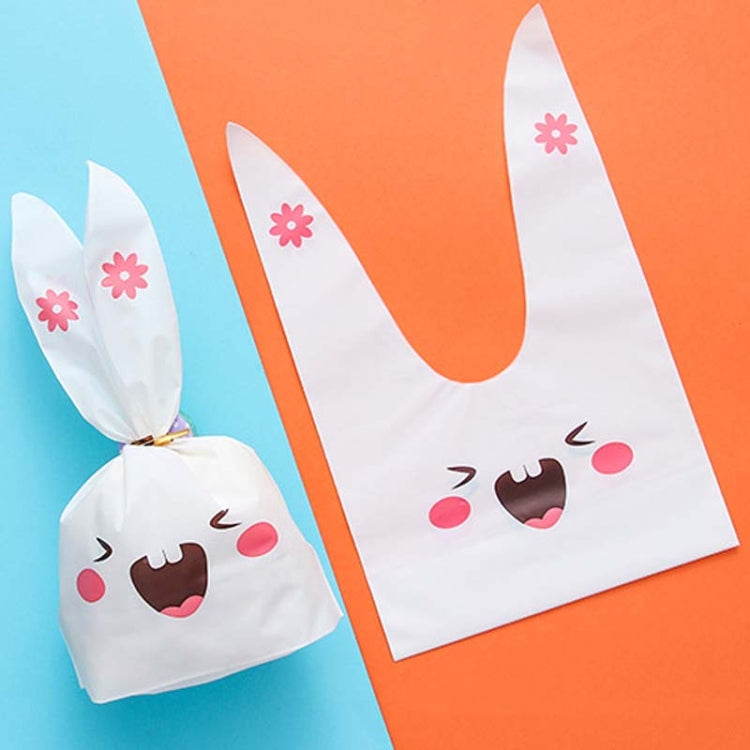 Rabbit-ear gift bag, white with pink flower accents and cartoon bunny face design.