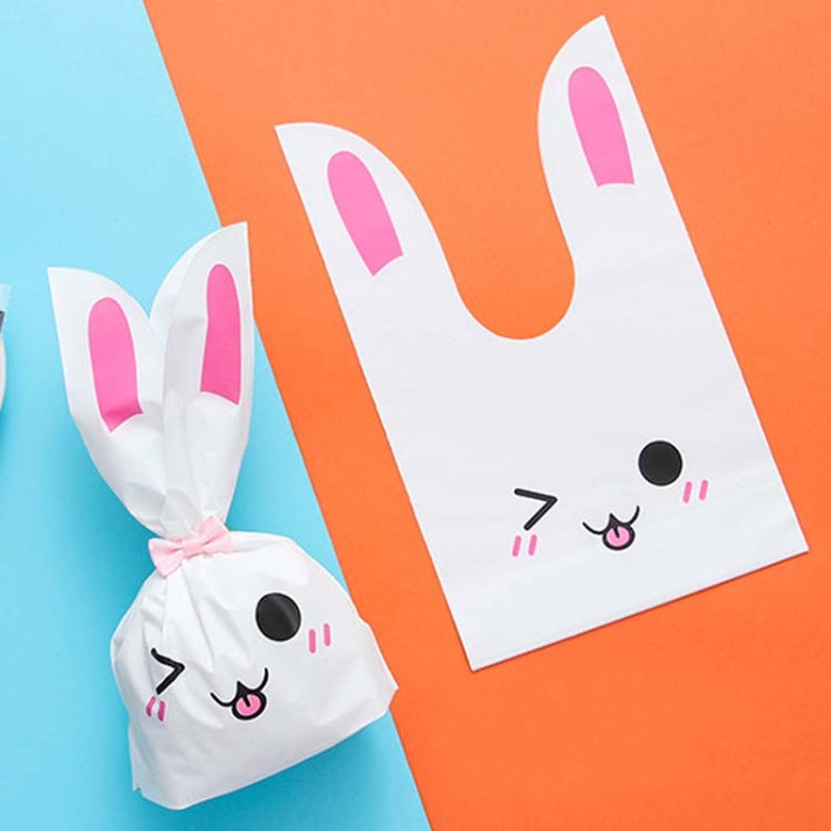 Rabbit-ear gift bag, white with pink inner ears and smiling cartoon bunny face.