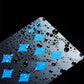 Close-up of waterproof PVC playing card with blue pattern and water droplets
