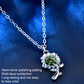 Silver sunflower pendant necklace with green round center stone, scalloped frame, and links