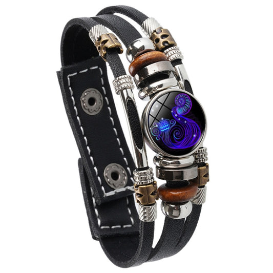 Black leather rope bracelet with silver beads and blue glowing zodiac pendant