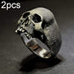 Silver-tone skull ring, front view, showing etched cracks and detailed teeth