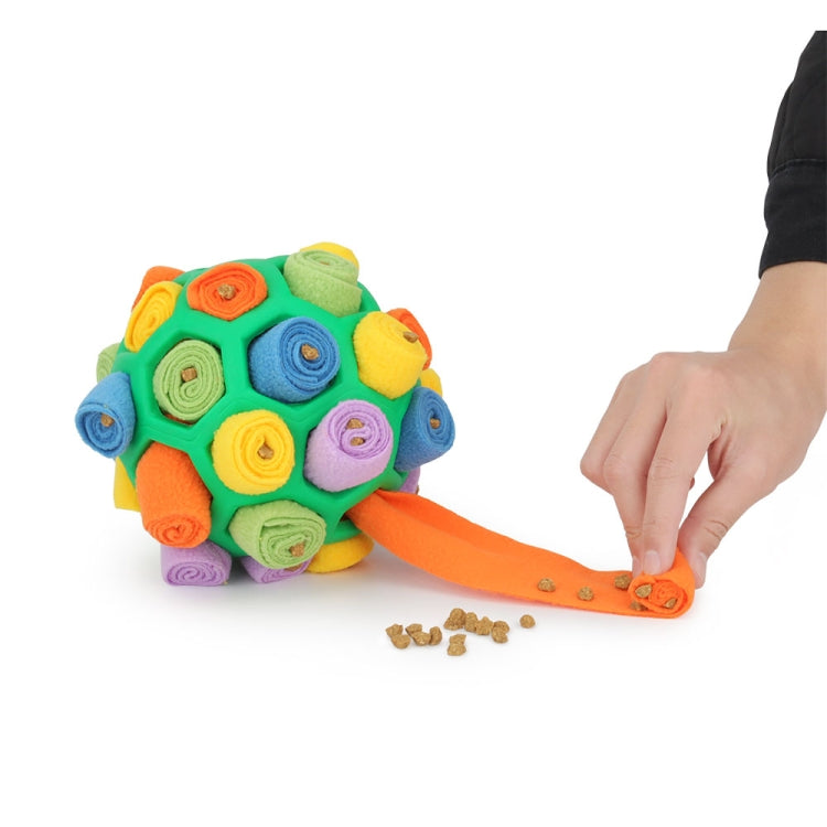 Rainbow plush dog sniffing ball toy with orange access flap and scattered treats