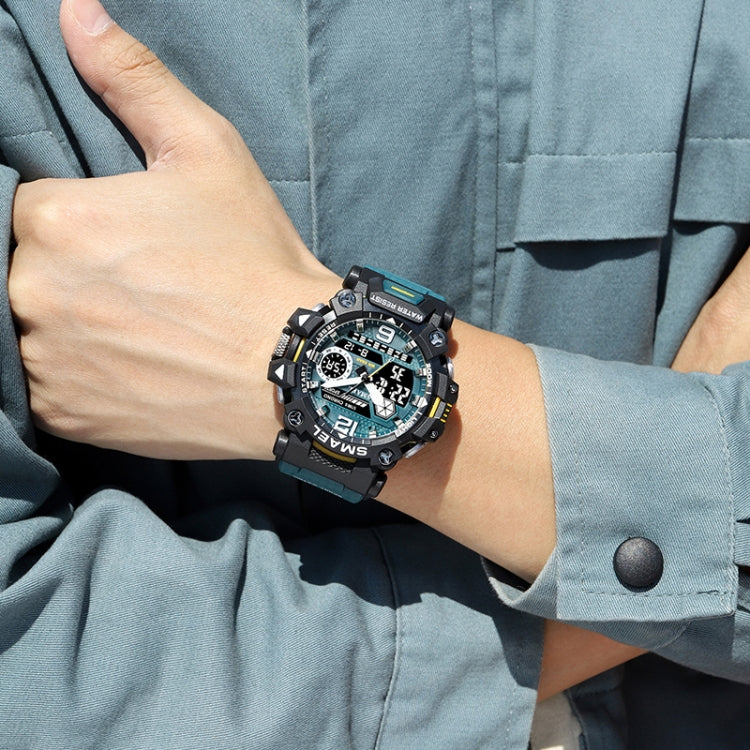Men's dual-display digital sports watch worn on wrist with black case and blue strap