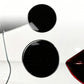 Two round black fuel cap stickers with chrome rims