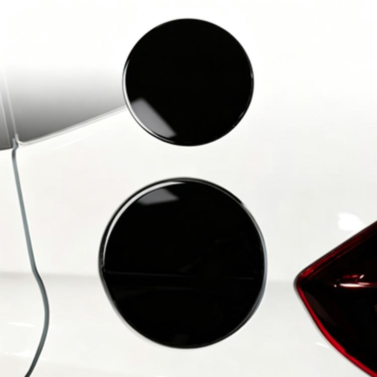 Two round black fuel cap stickers with chrome rims