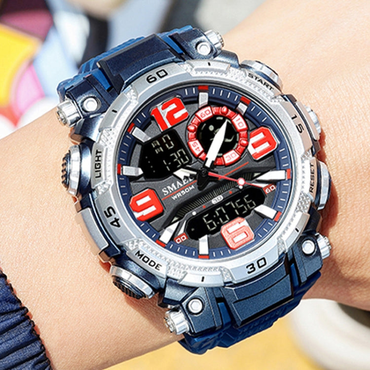 Men's sports watch on wrist, blue rubber strap and silver case with red-accent dial