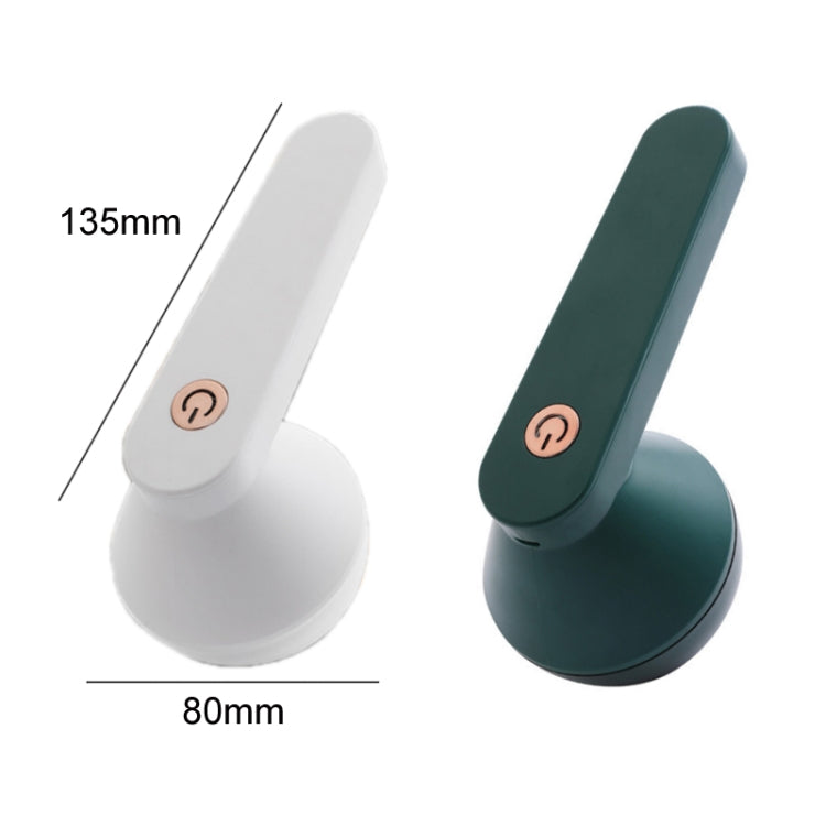 Green lint remover trimmer shown from side, with circular head and switch