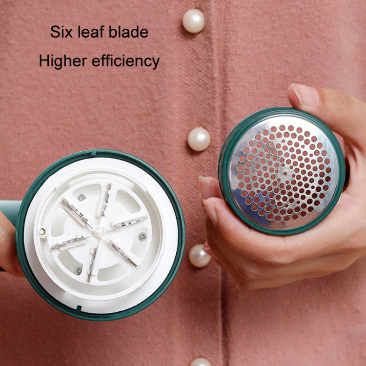 Green trimmer head with perforated grill and visible internal blades
