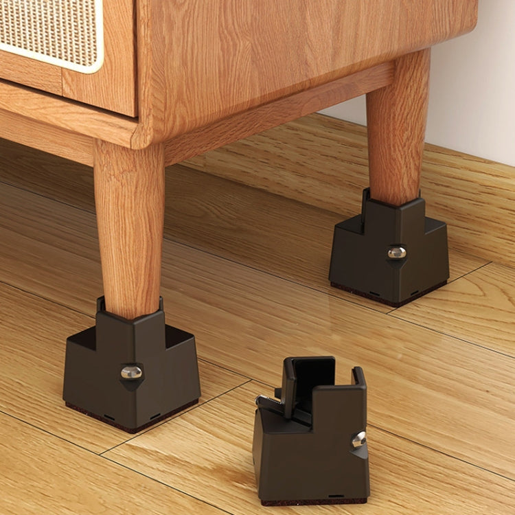 Four black clip-on furniture heightening feet pads attached to wooden furniture legs