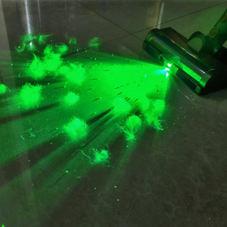 Green LED glow from vacuum roller brush light with dust and debris effects