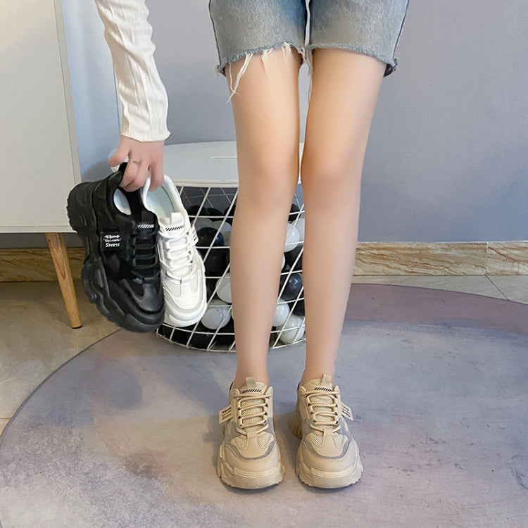 Sports shoes on model’s feet, black and white chunky lace-up sneakers