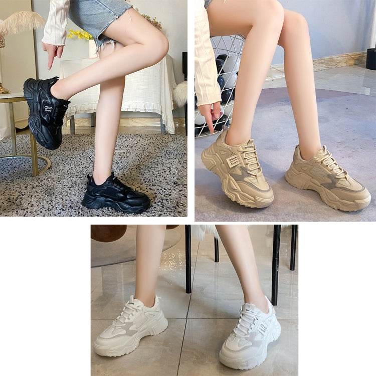 Model wearing chunky sports shoes in black, beige, and white colors