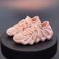 Pink knit sock shoes with mesh upper, lace-up front, and cushioned sole view