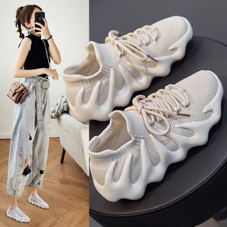 Pair of white knit sock sneakers on a platform with thick ridged sole