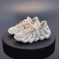 Beige woven sock shoes with lace-up closure, textured mesh upper, cushioned sole