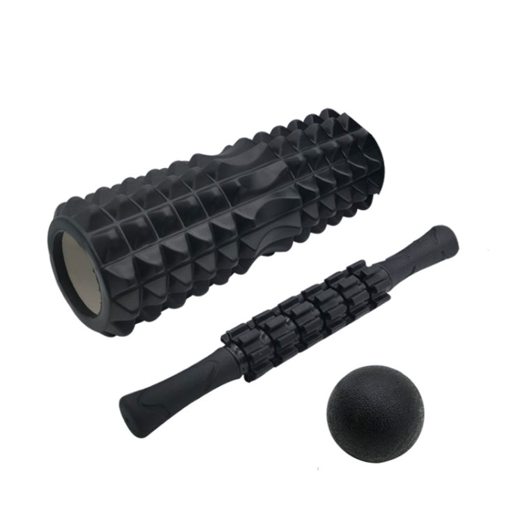 Black foam roller set with ridged roller, massage stick, and dark exercise ball