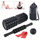 Black foam roller set with massage ball, foam stick, red drag band, storage bag