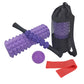 Purple foam roller set with black massage stick, purple ball, red resistance bands, bag