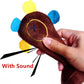 Brown plush monkey dog toy close-up in hand, showing circular sound button and feet