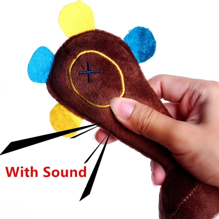 Brown plush monkey dog toy close-up in hand, showing circular sound button and feet