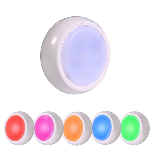 White circular bedside night light with glowing blue inner panel