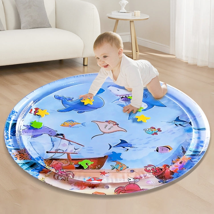 Inflatable shark water play mat on floor with baby standing and smiling, blue