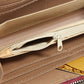 Brown zipper coin purse close-up with beige lining and metal zipper pull