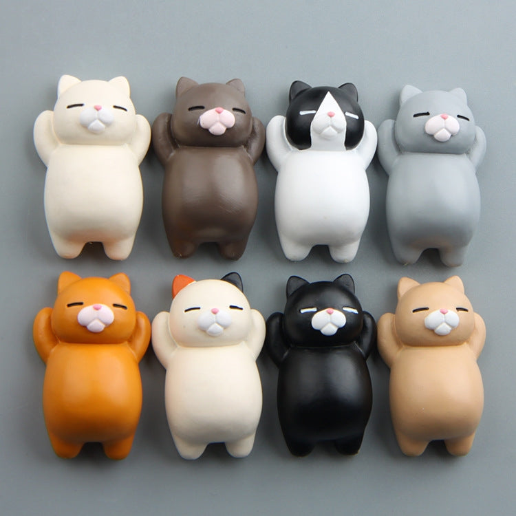 Multiple cartoon cat resin fridge magnets, mixed colors arranged in two rows.