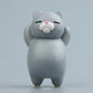 Light gray cartoon cat resin fridge magnet, standing figure with pink nose and closed eyes.