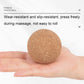 Tan cork massage ball resting in an open palm.