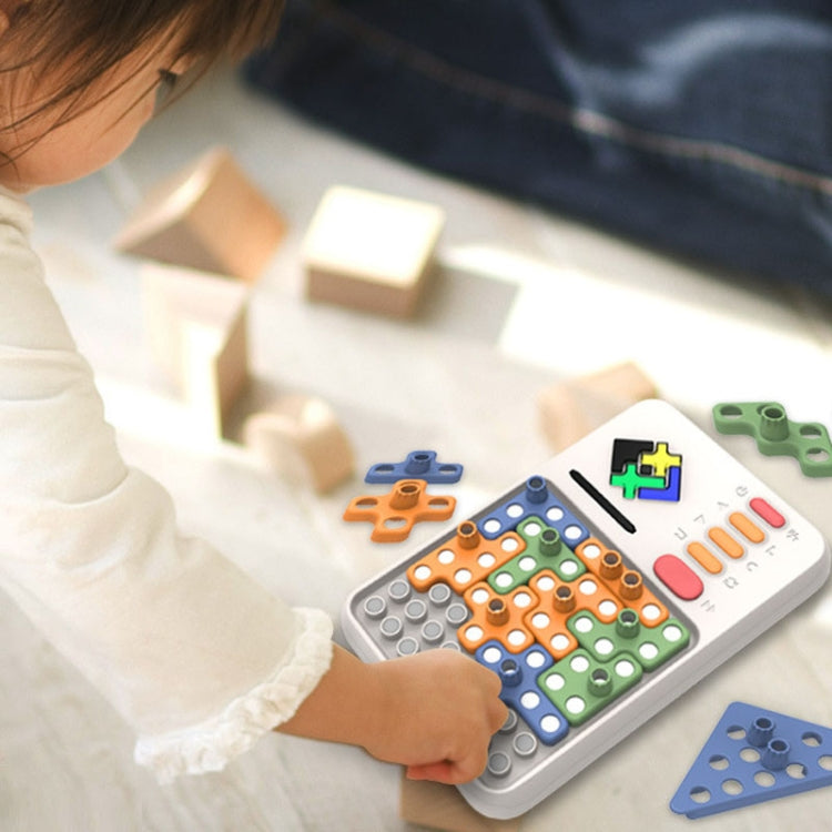 Child playing an electronic tangram puzzle on a white handheld board with colorful pieces