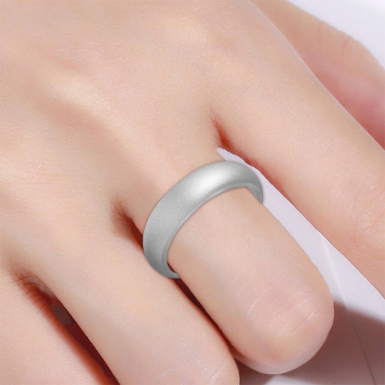 Wide silver silicone ring on finger