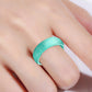 Turquoise wide silicone glitter ring on finger, smooth band finish