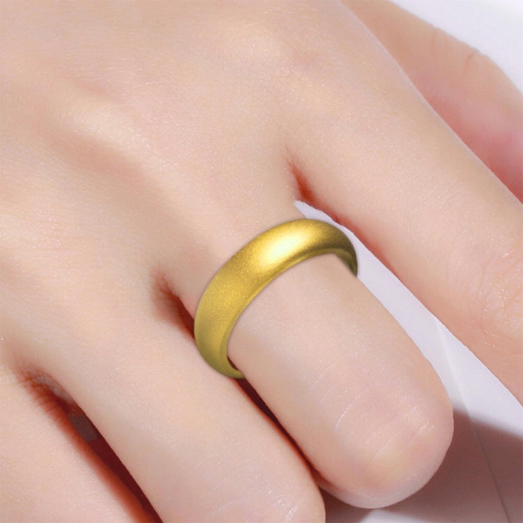 Gold tone wide silicone ring worn on finger