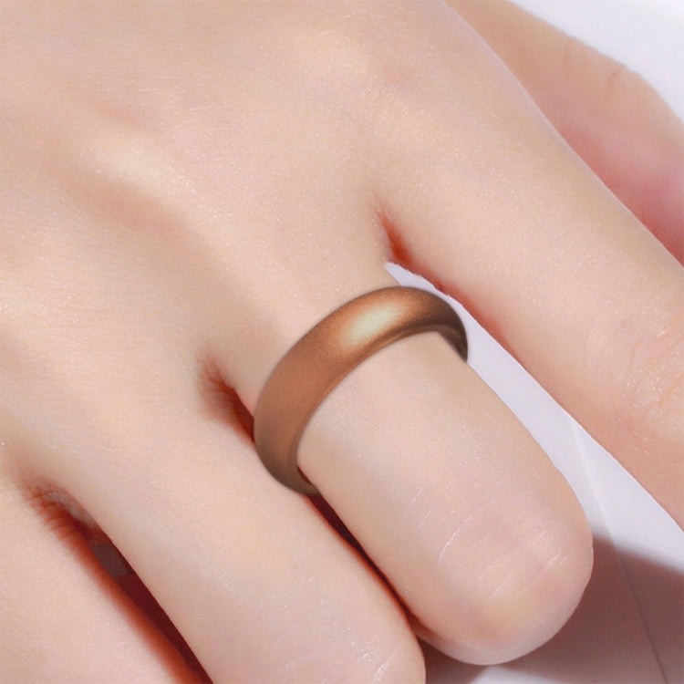 Wide bronze silicone ring on finger, close-up