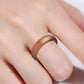 Wide bronze silicone ring band on finger, close-up