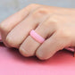 Pink glitter silicone ring band on finger
