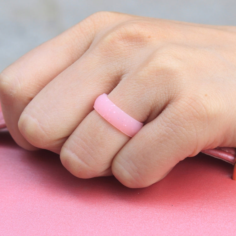Pink glitter silicone ring band on finger