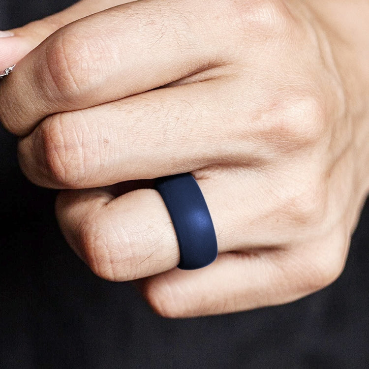 Curved dark blue silicone sports ring on finger, matte finish