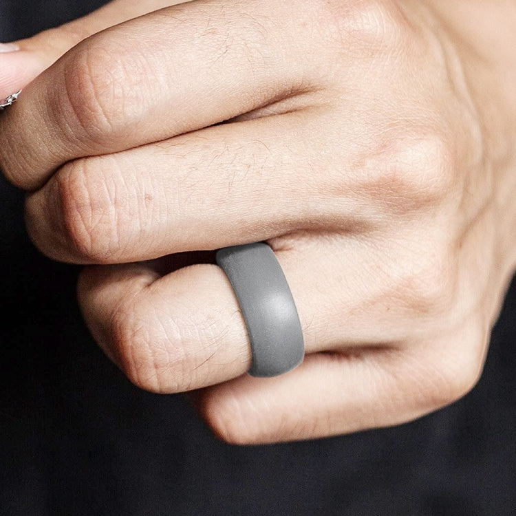 Curved dark gray silicone sports ring worn on hand, matte curved band